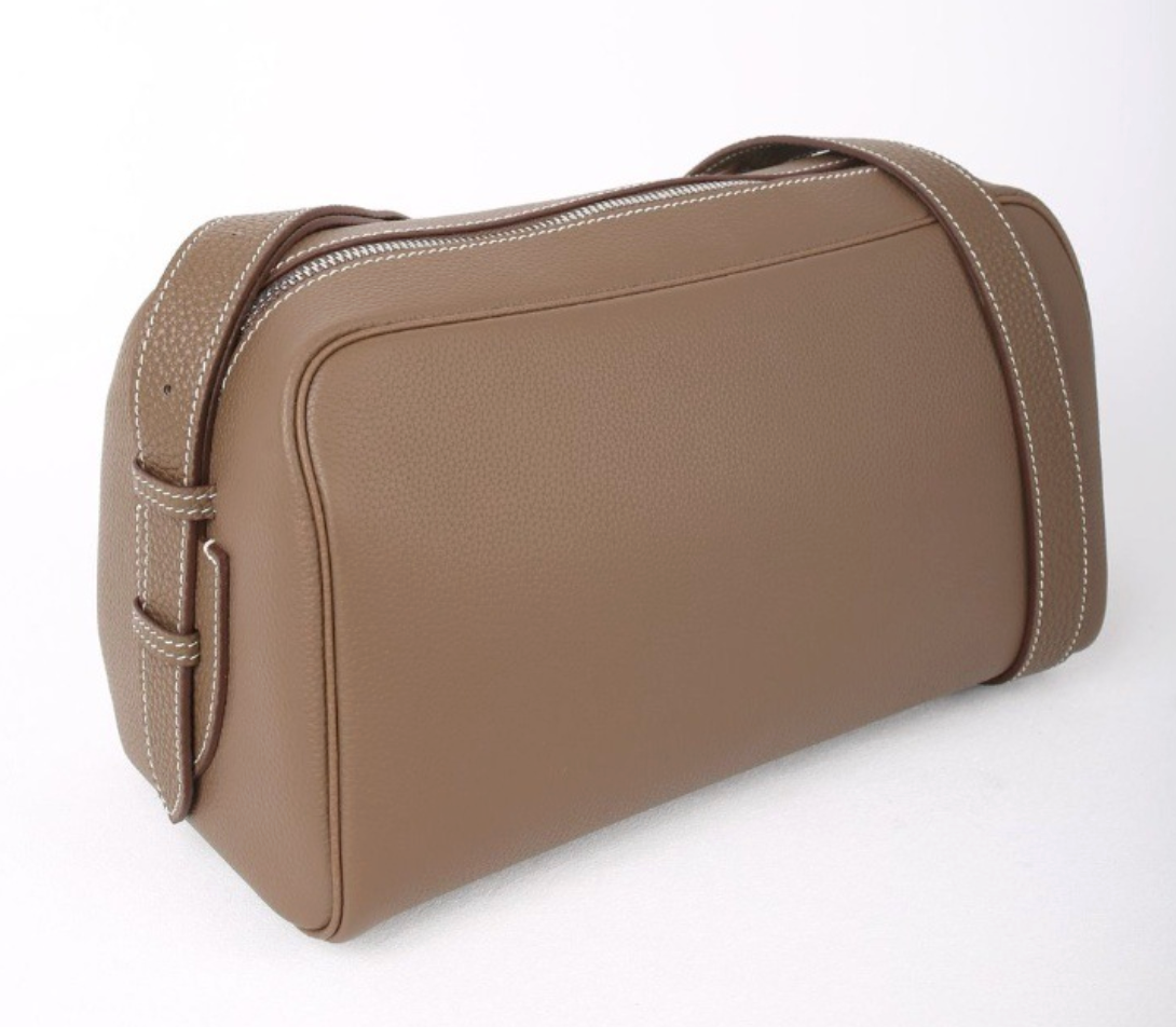 Brown toiletry bag on a white background