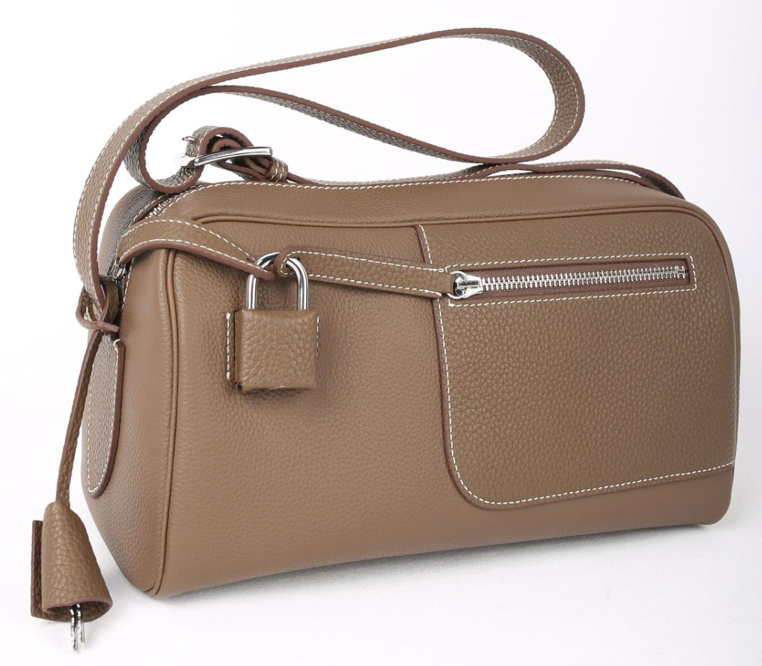 Brown leather handbag with a lock on a white background