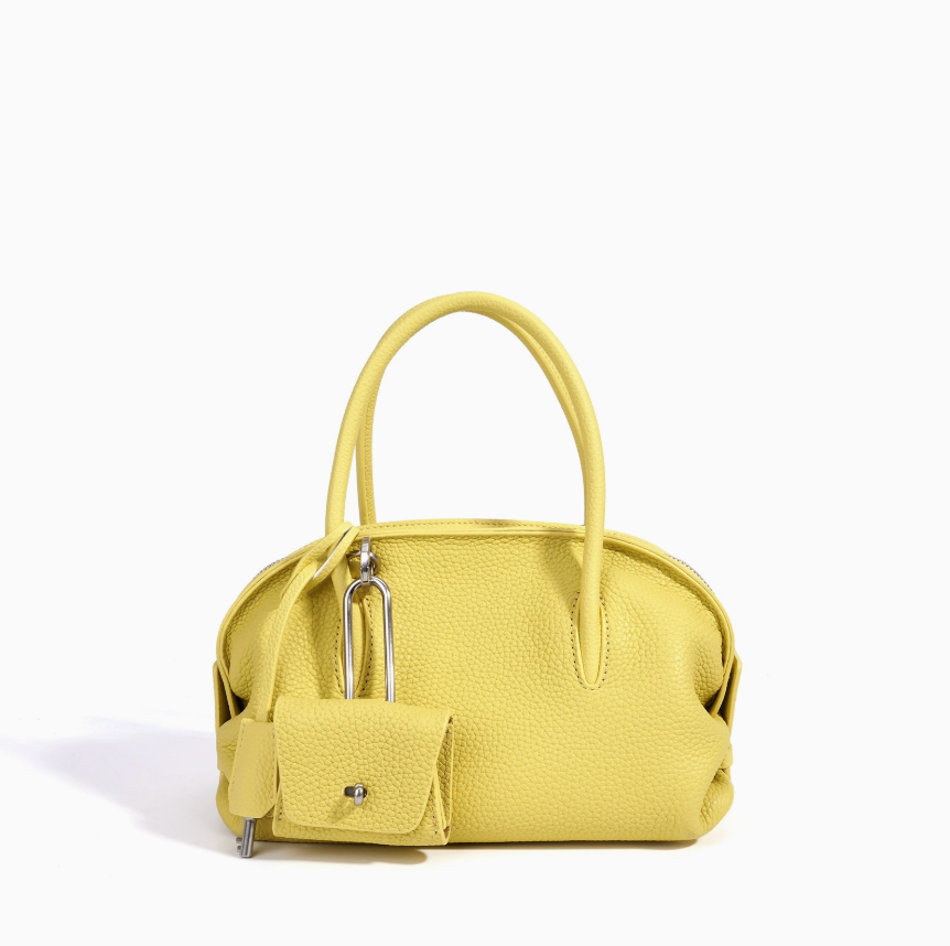 Yellow handbag with a smaller attached pouch on a white background