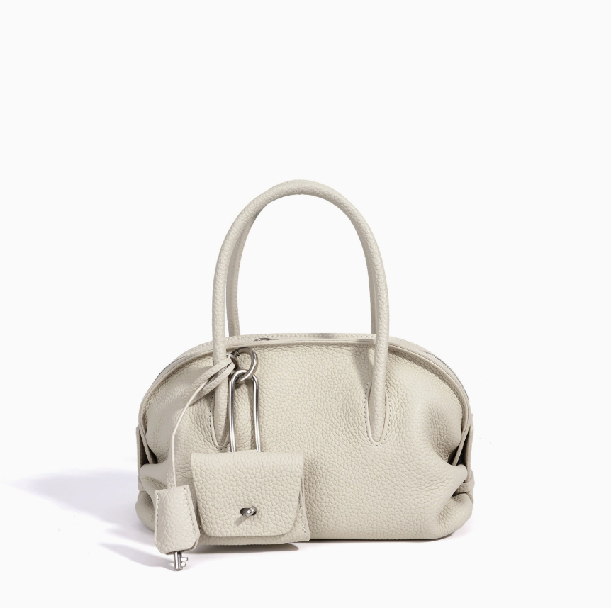 Light gray handbag with a smaller matching pouch on a white background