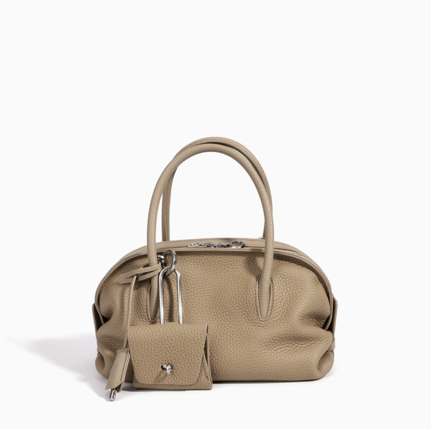 Beige handbag with matching pouch on a white background