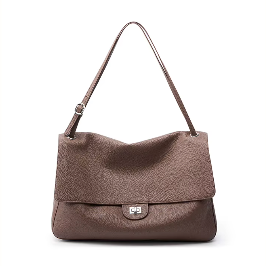 A brown pebbled leather shoulder bag with a single adjustable strap and a silver-tone turn-lock clasp on a plain white background.