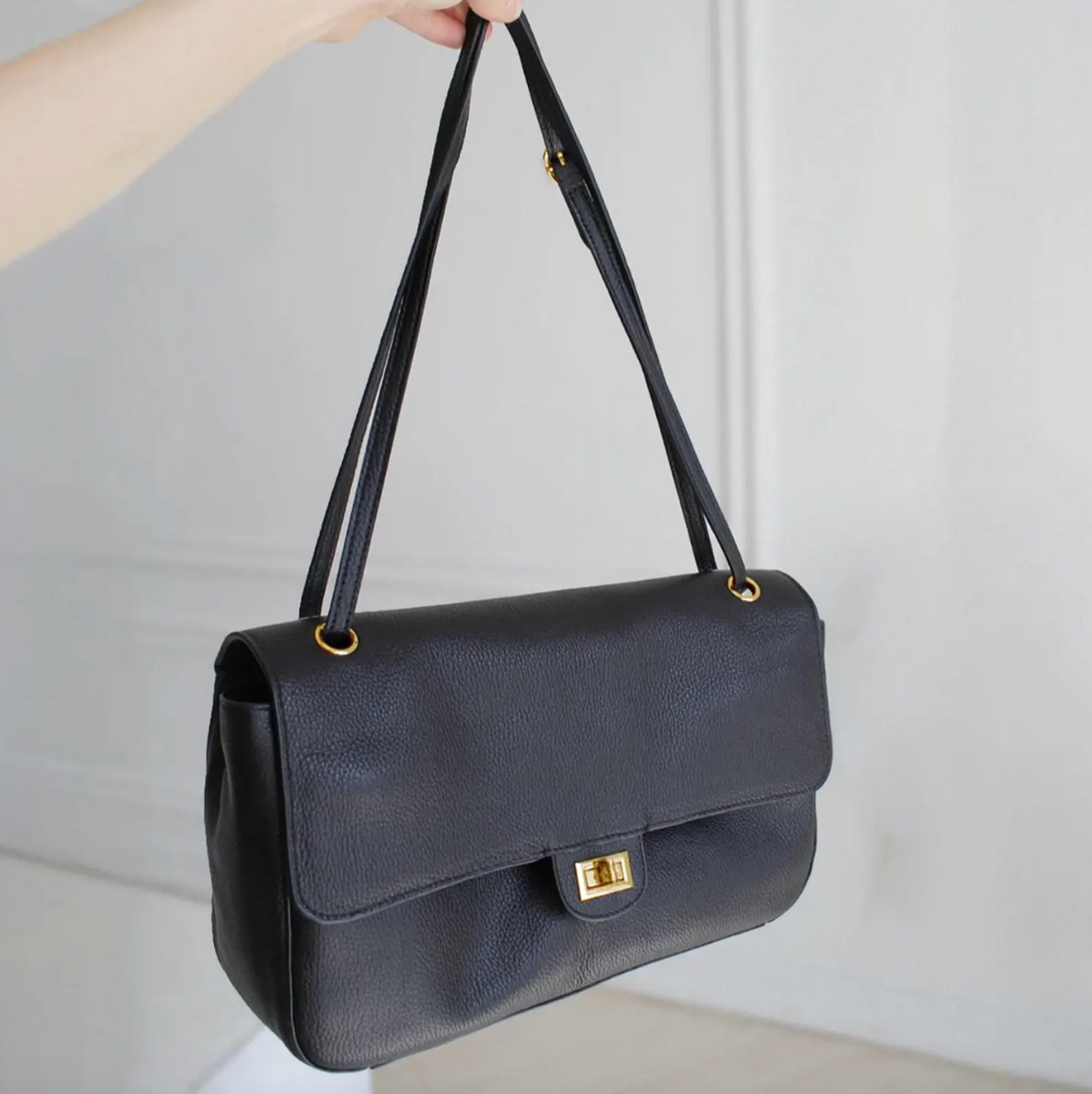 Hardware detail on the Venebag Turn-Lock Crossbody, gold and silver options