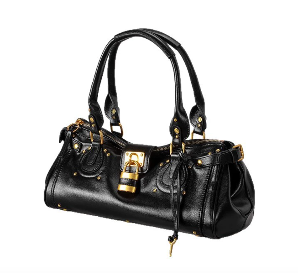 Black handbag with gold accents on a white background