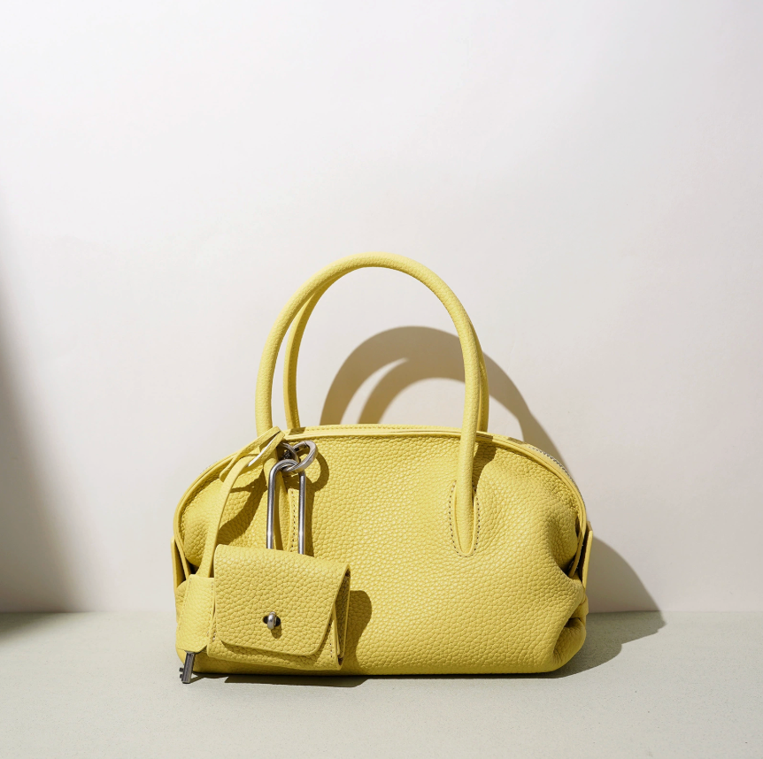 Yellow handbag on a light background