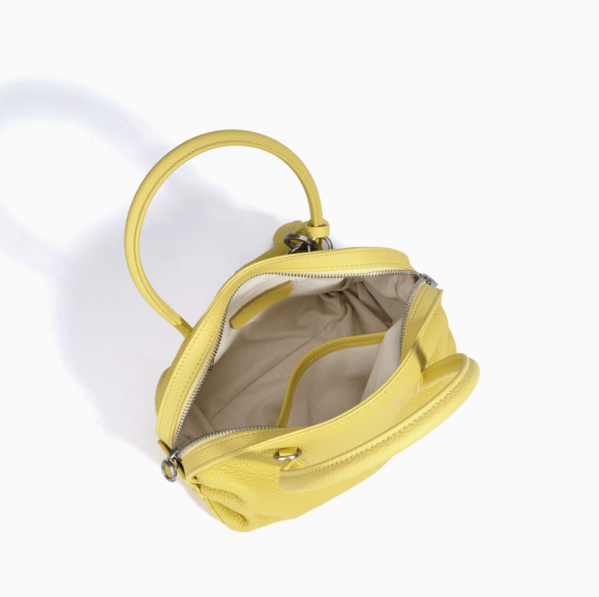 Yellow handbag with open top on a white background