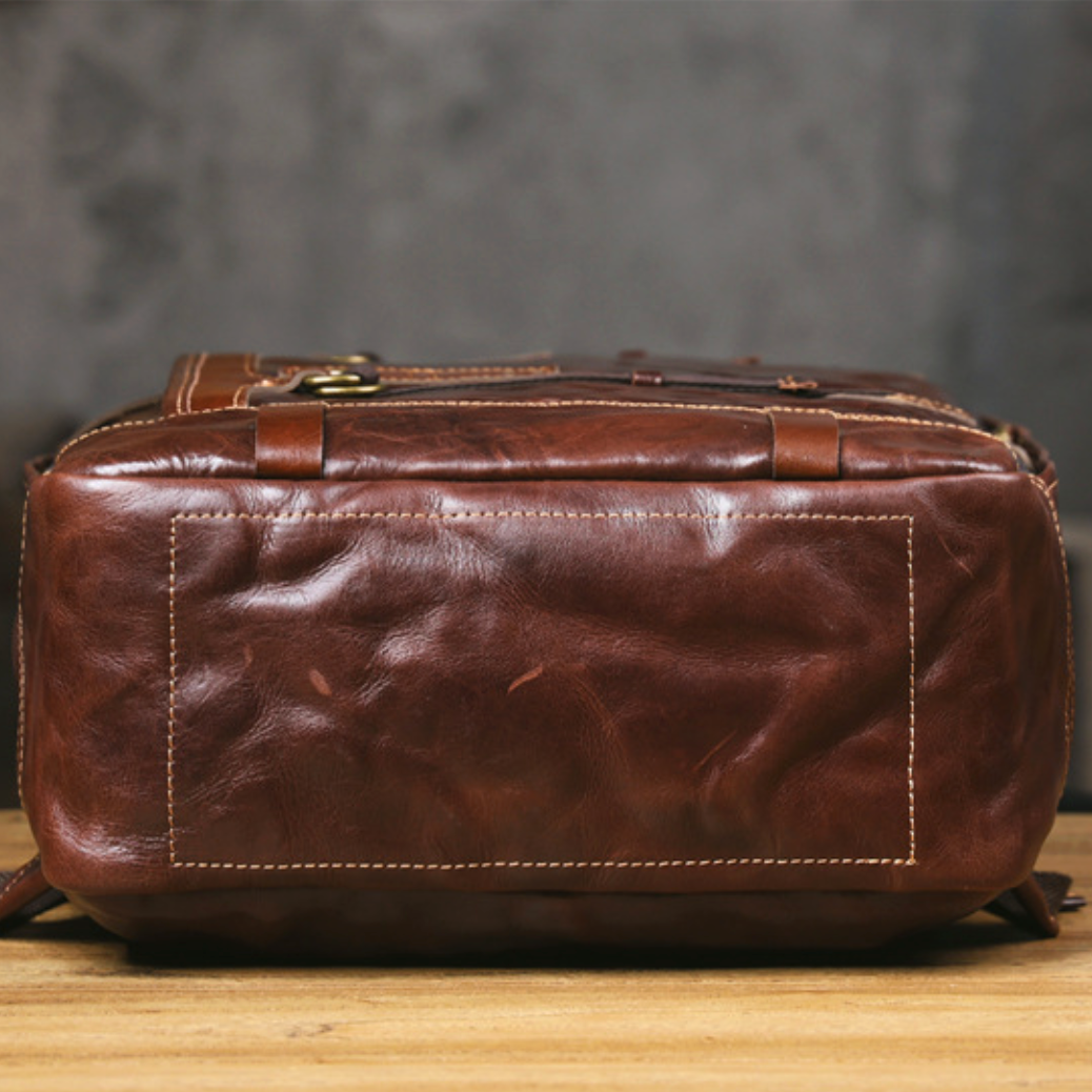 Brown leather bag on a wooden surface with a blurred background