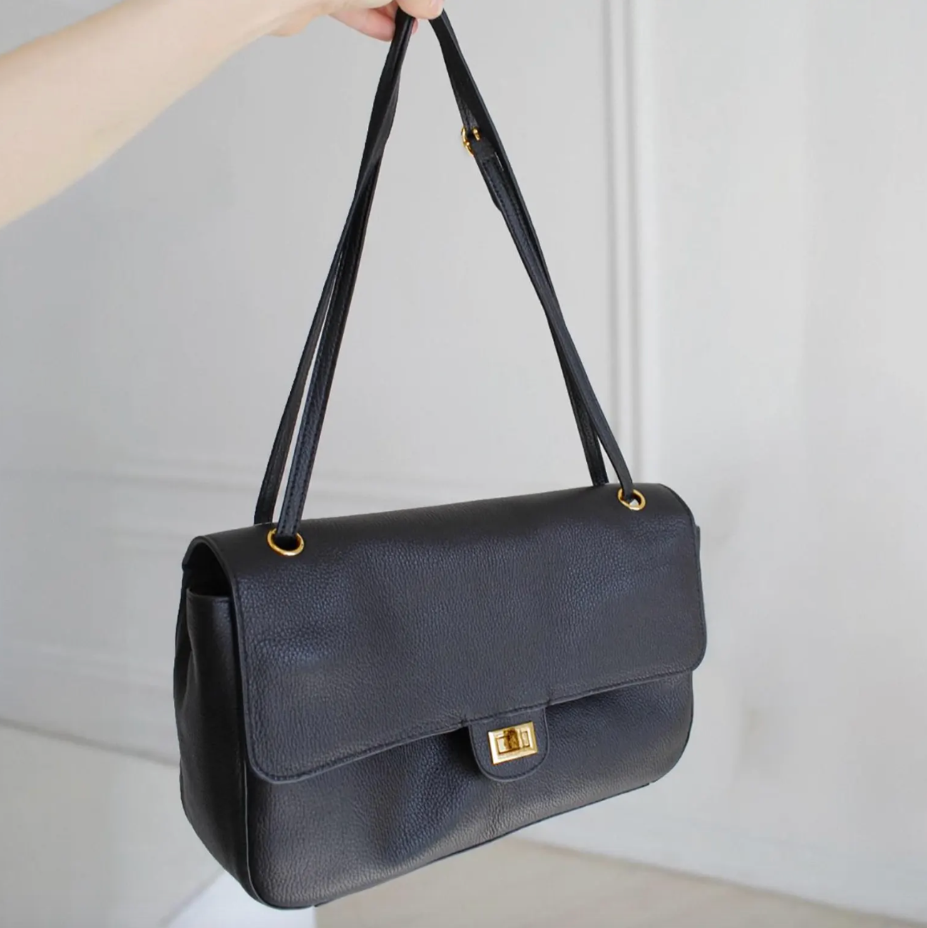 Hardware detail on the Venebag Turn-Lock Crossbody, gold and silver options