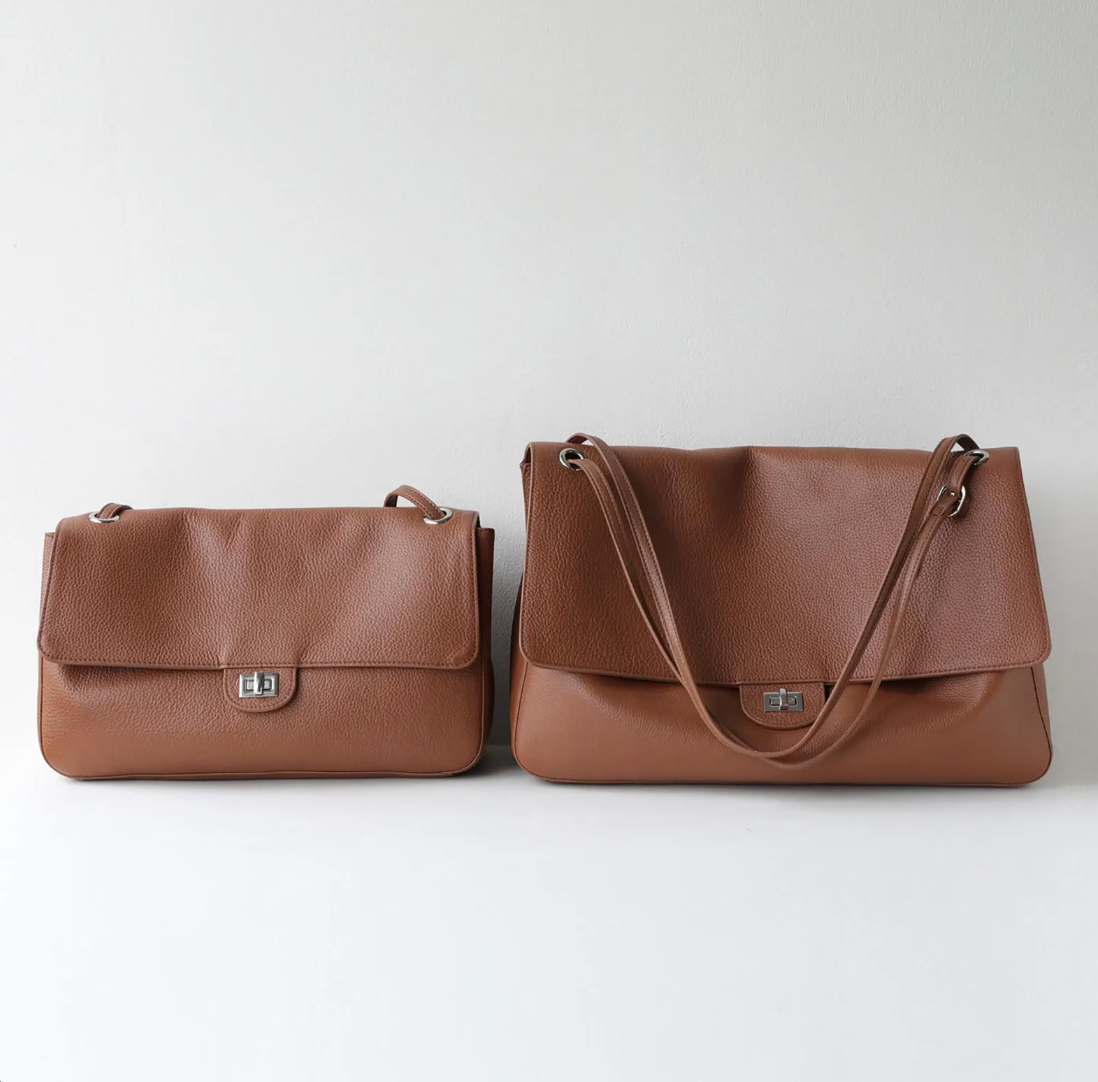 Hardware detail on the Venebag Turn-Lock Crossbody, gold and silver options