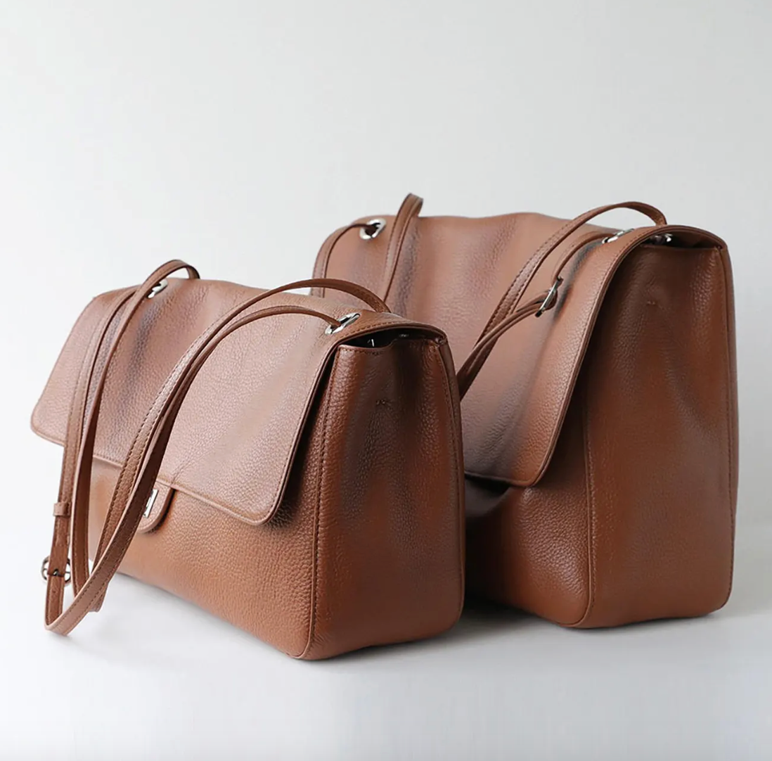 Hardware detail on the Venebag Turn-Lock Crossbody, gold and silver options
