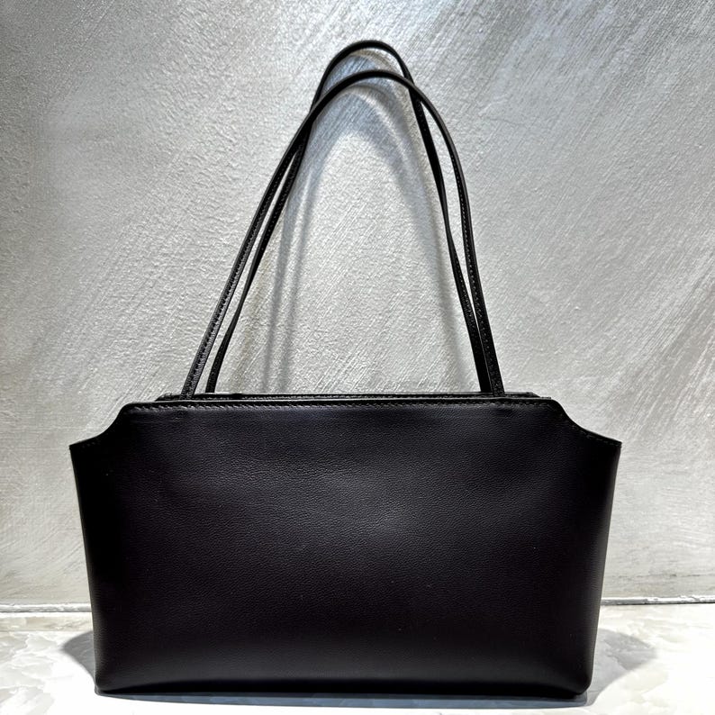 The Venebag Bare Shoulder Bag shown at scale for size reference